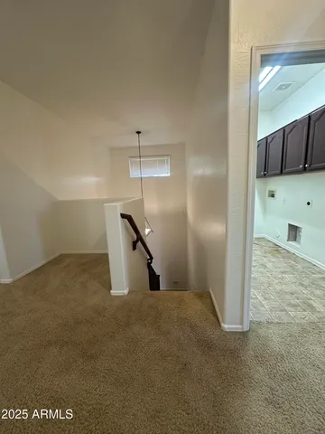 an empty room with a ceiling fan and window