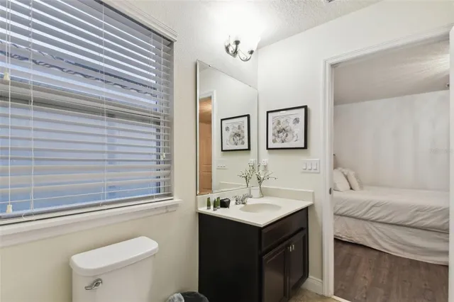 a spacious bedroom with a bed and a chandelier