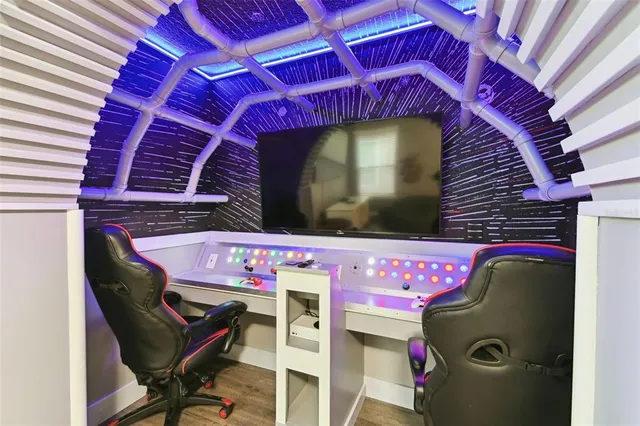 a living room with furniture kitchen view and a chandelier
