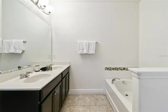 an aerial view of residential houses with outdoor space and trees all around