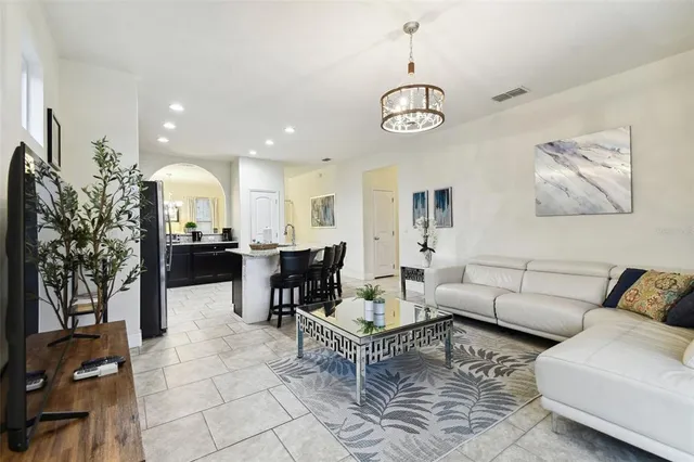a view of a dining room with furniture and chandelier