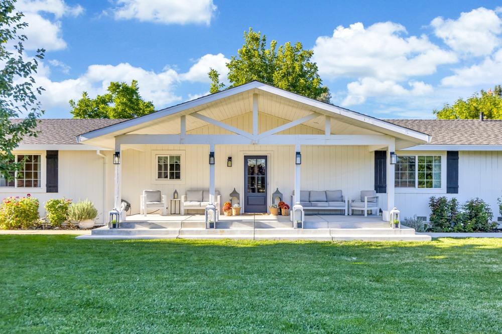 a front view of house with yard and outdoor seating