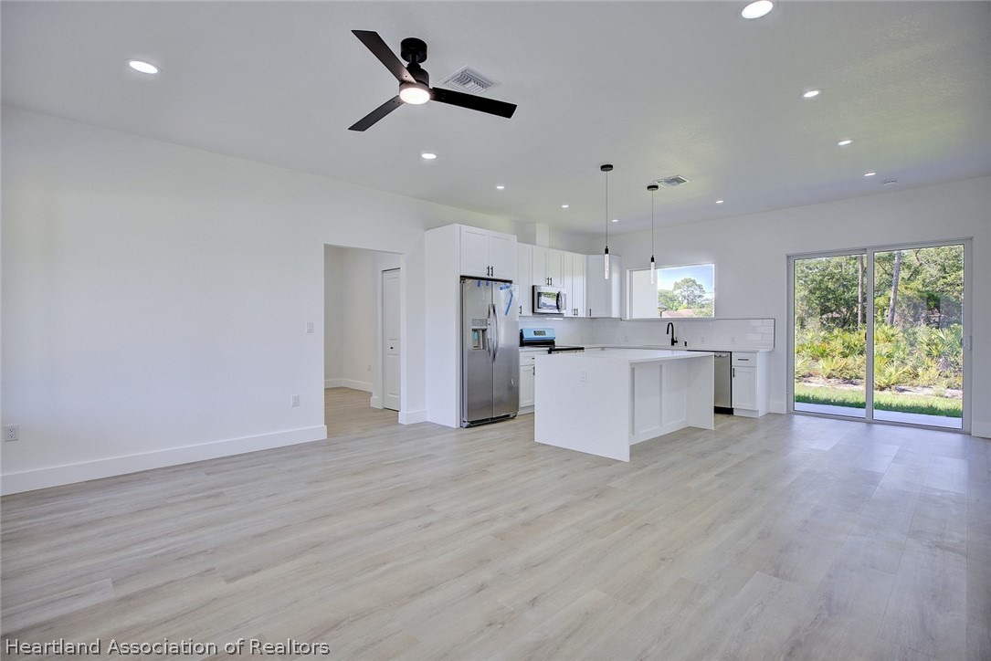 4307 Talbot Street Sebring, FL 33872 - Photo 3 of 19 a view of a kitchen with furniture and wooden floor
