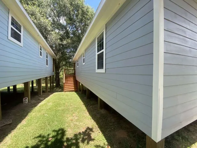 a view of a backyard with a large tree