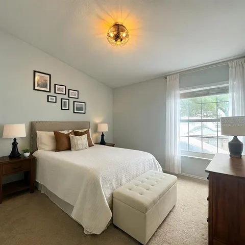 a bedroom with a bed and a couch