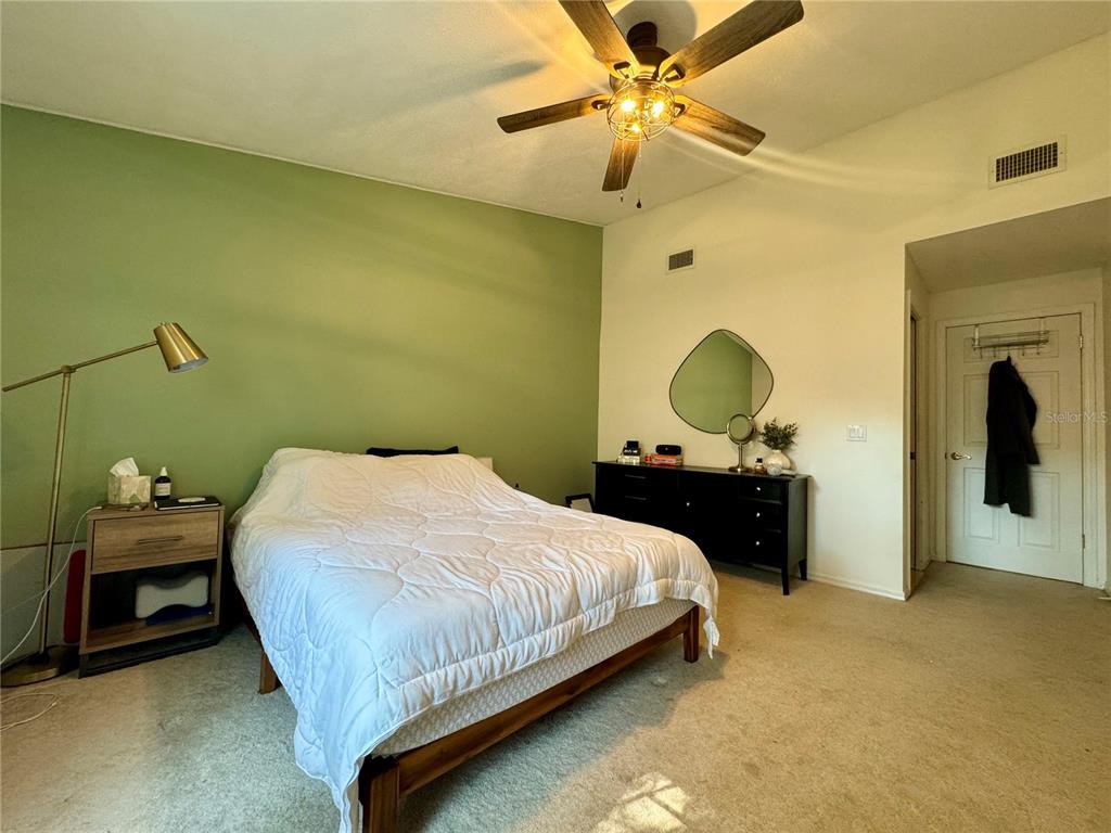 5169 Lazy Oaks Drive Winter Park, FL 32792 - Photo 16 of 25 a bedroom with a bed and a chandelier