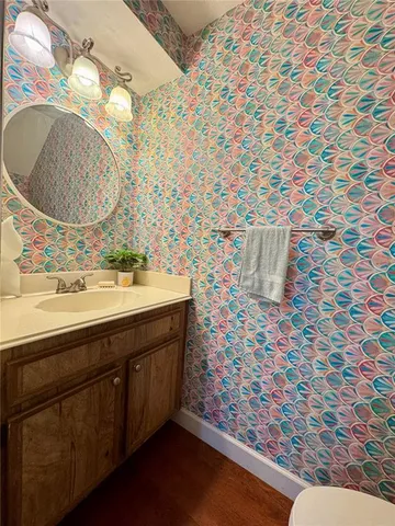 a bathroom with a sink mirror and vanity