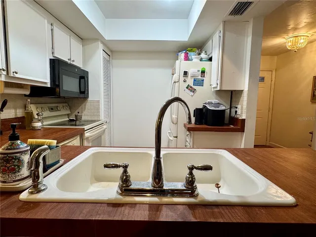 a bathroom with a sink a large mirror and a sink