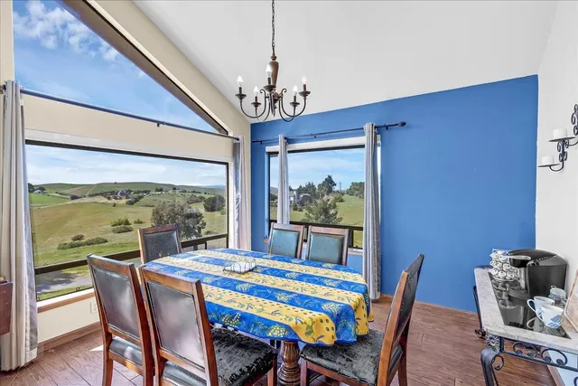 a dining room with furniture a window and a chandelier