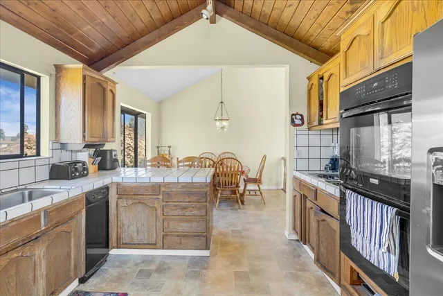 a kitchen with stainless steel appliances granite countertop a sink stove and cabinets