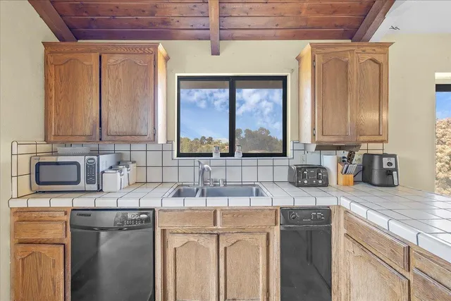 a kitchen with a sink a stove and cabinets