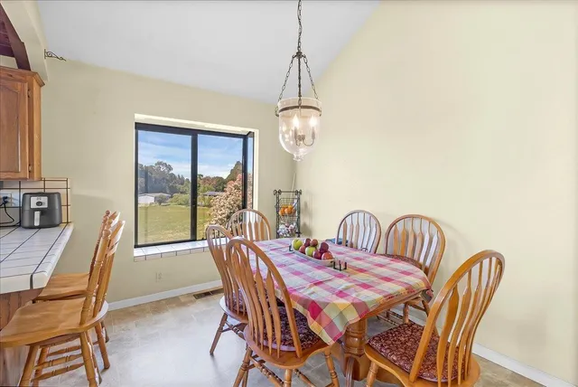 a view of a dining room with furniture window and outside view
