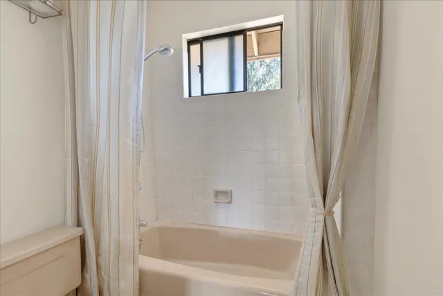 a bedroom with a bed and a dresser in it