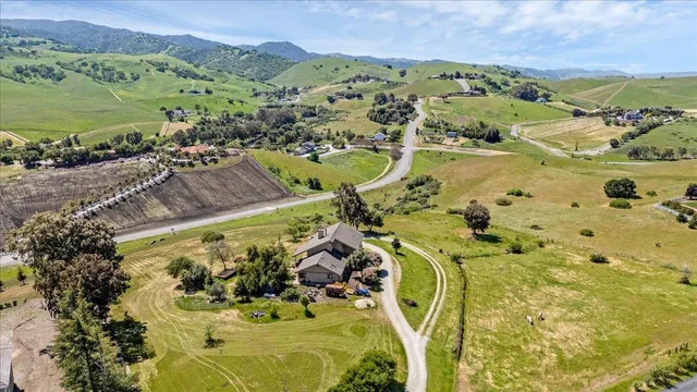 a view of a white house with a big yard and balcony