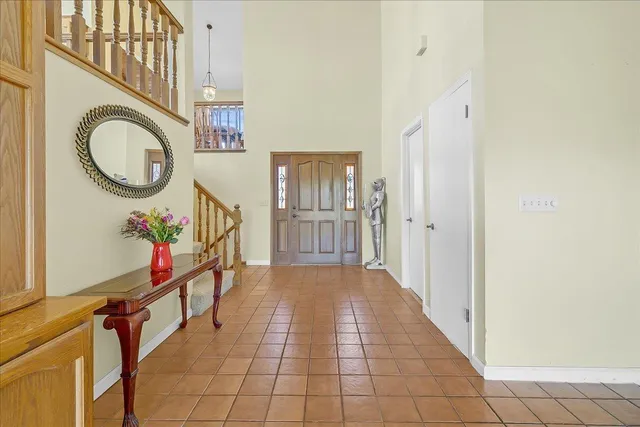 a view of a hallway with wooden floor and entryway