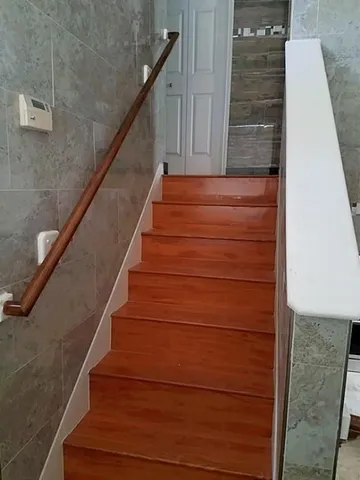 a bathroom with a granite countertop toilet and a shower