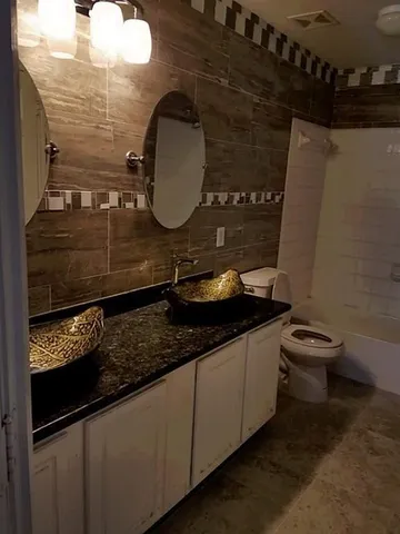 a view of a bathroom with wooden floor and a window