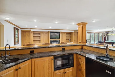 a kitchen that has a sink and a stove in it
