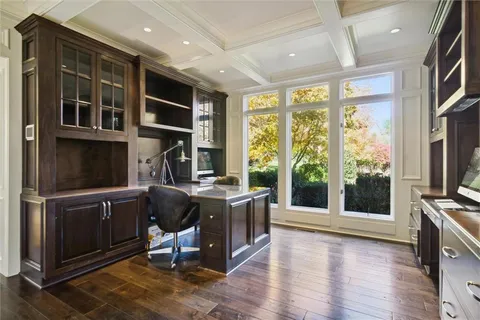 a view of a kitchen with fridge and wooden floor