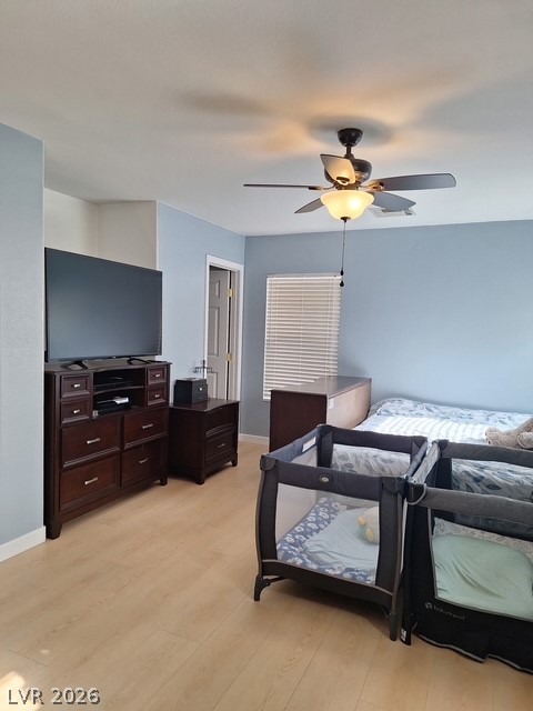 5171 Piazza Cavour Drive Las Vegas, NV 89156 - Photo 12 of 13 Well-lit sleeping quarters with elegant wood-tone flooring and a ceiling fan for optimal air circulation.