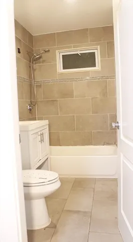a bathroom with a toilet a sink and bathtub