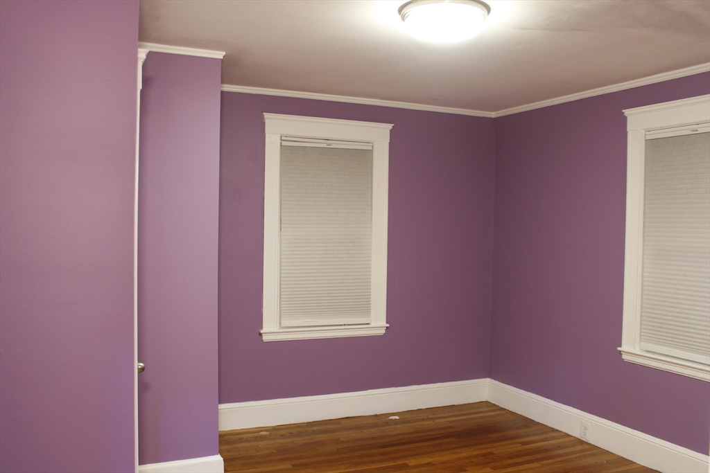 45-47 Coolidge Road, Unit 2 Boston, MA 02134 - Photo 8 of 11 a view of empty room with window and wooden floor