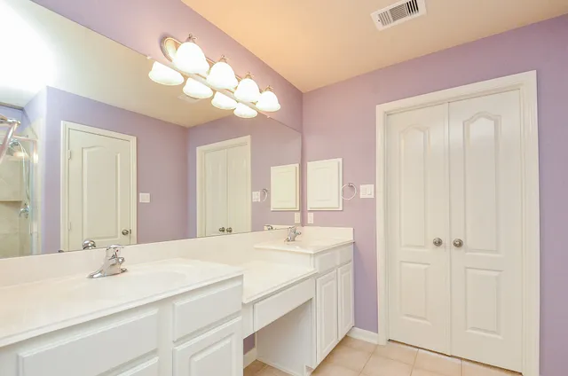a bathroom with a sink vanity and a mirror