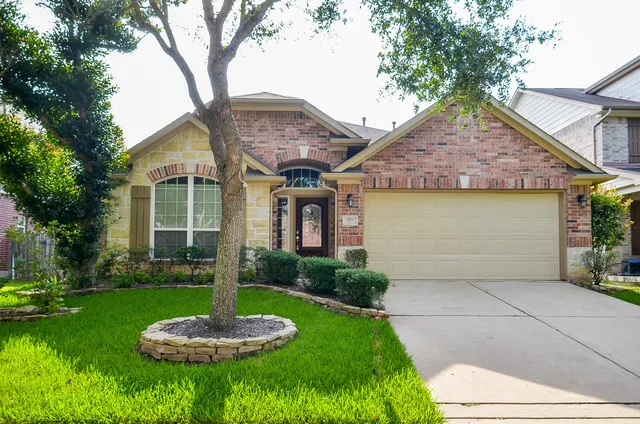 a front view of a house with a yard and garage