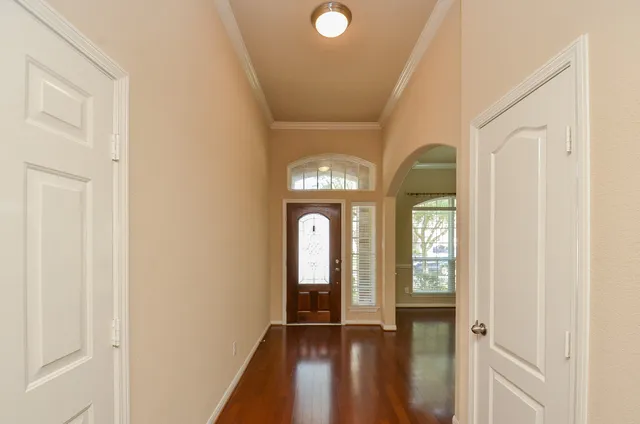 a view of a livingroom with wooden floor and a window