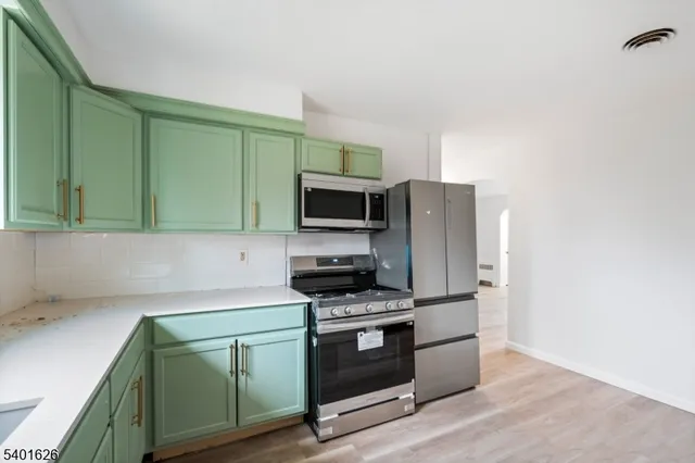a kitchen with a sink cabinets and stainless steel appliances