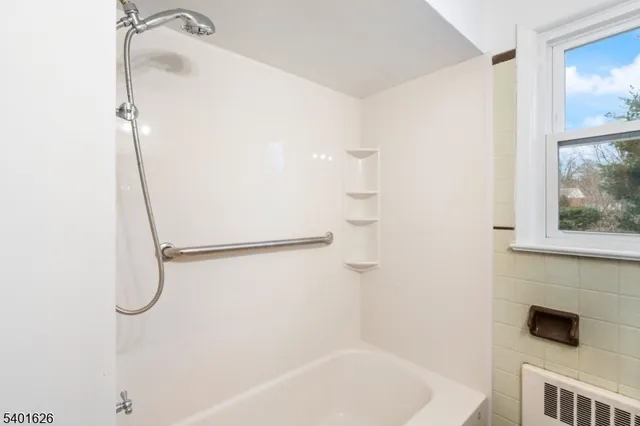 a bathroom with a shower and a bathtub