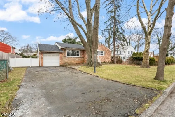 a view of a yard with a house and a tree