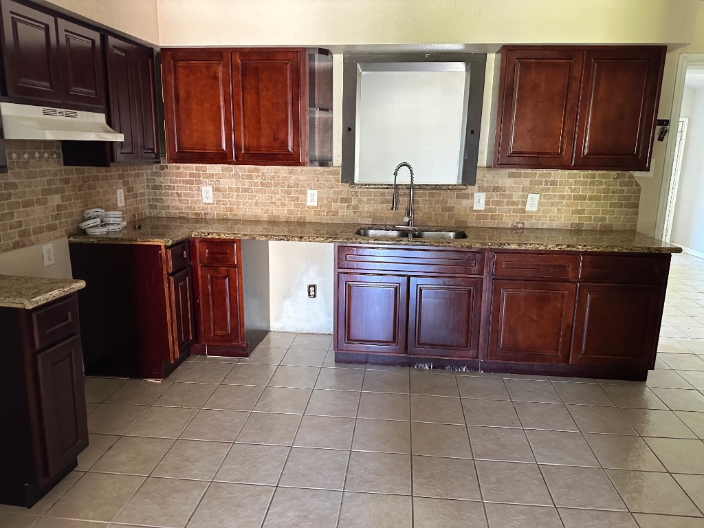 930 South Utah Street La Porte, TX 77571 - Photo 3 of 8 a kitchen with a sink a stove and cabinets