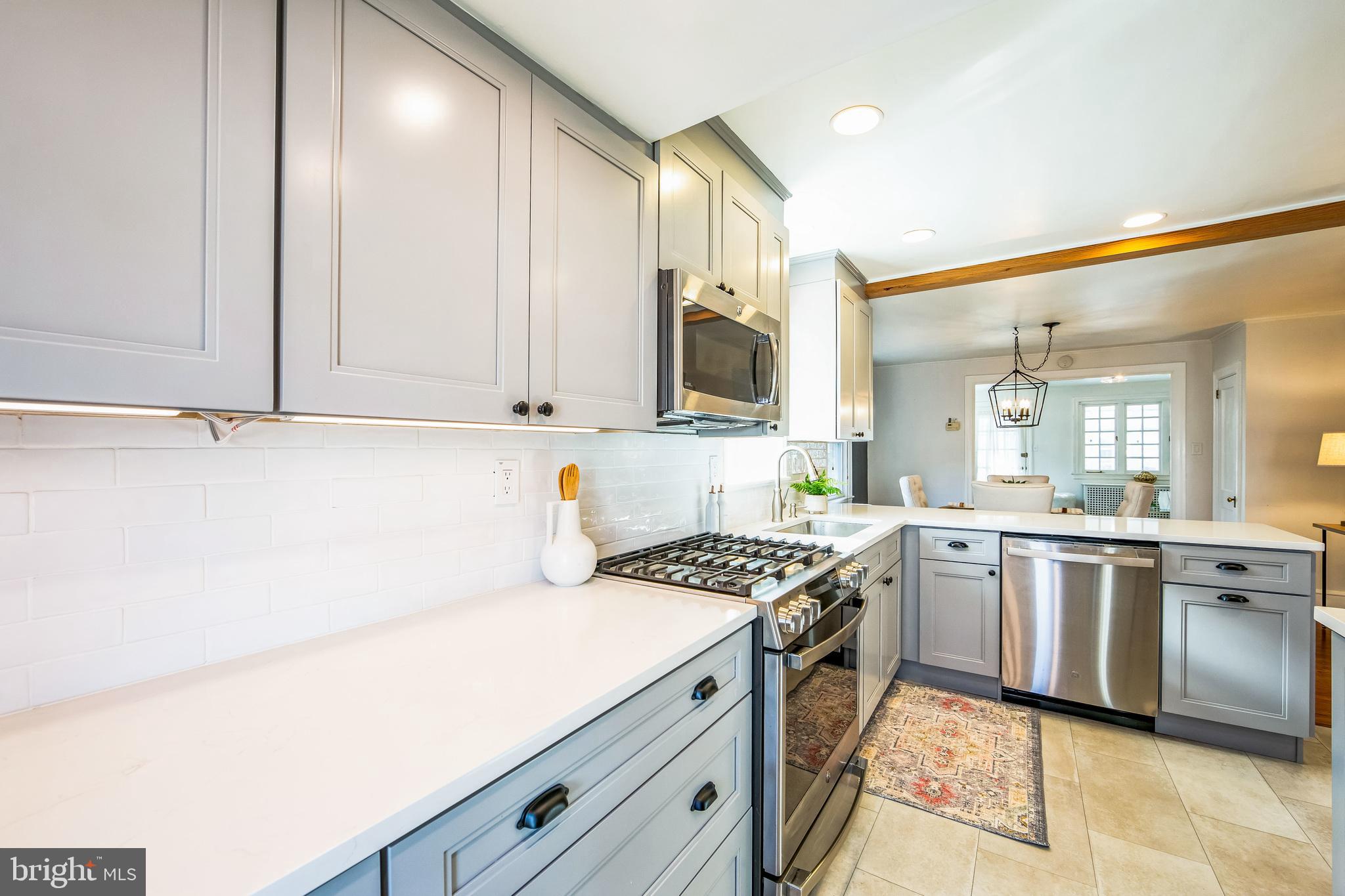 2423 Avon Road Ardmore, PA 19003 - Photo 16 of 37 a kitchen with stainless steel appliances a sink stove and cabinets