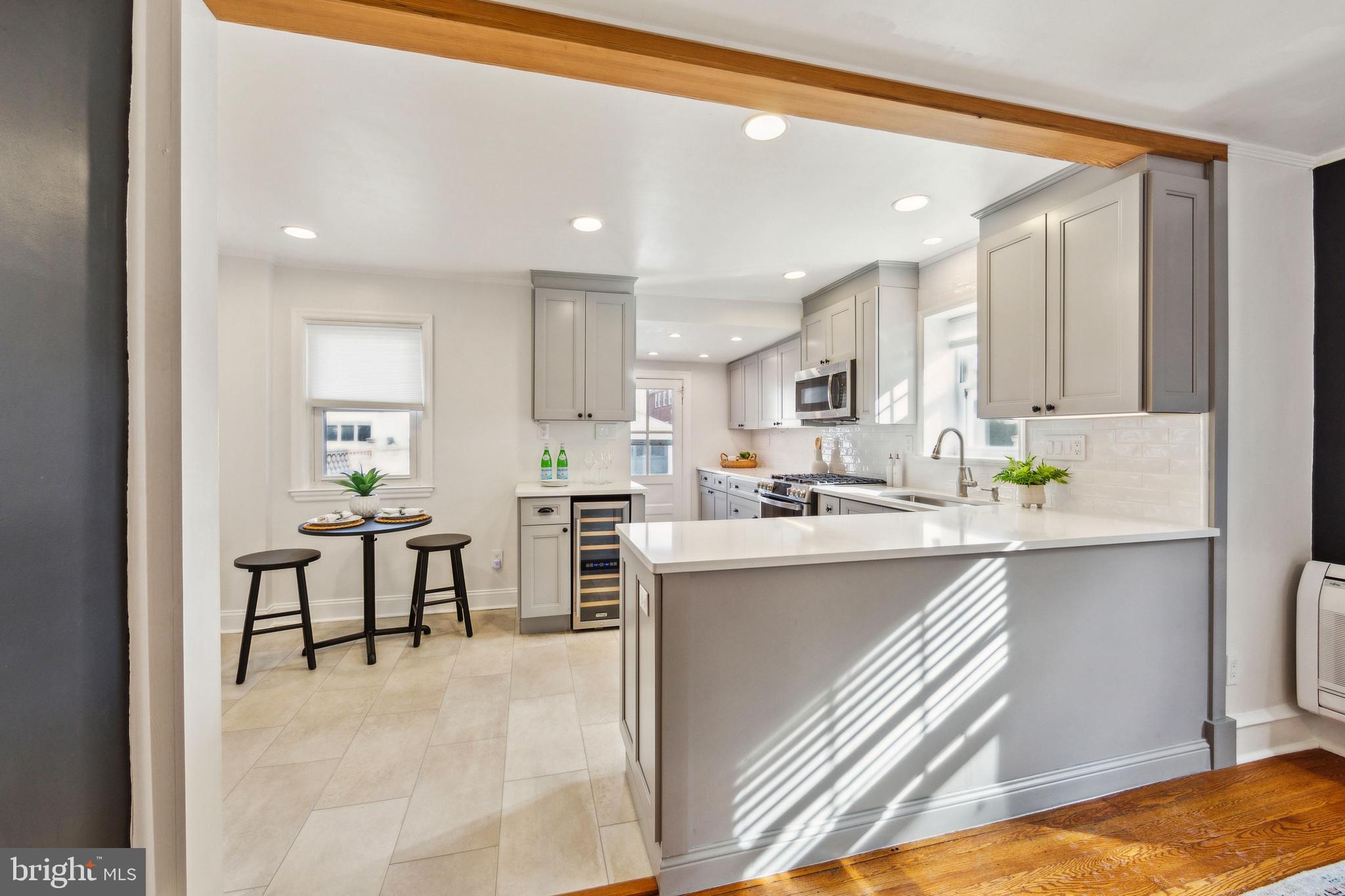 2423 Avon Road Ardmore, PA 19003 - Photo 19 of 37 a kitchen with white cabinets and chairs