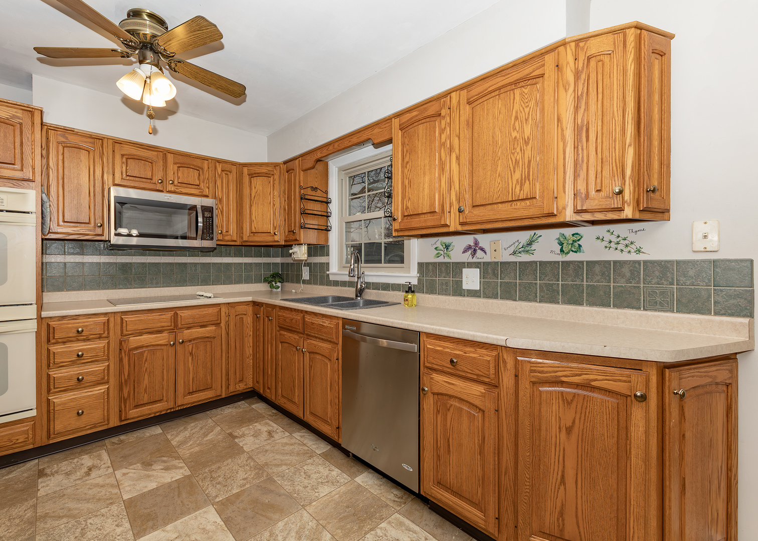 1109 14th Avenue Orion, IL 61273 - Photo 7 of 37 a kitchen with stainless steel appliances granite countertop a sink dishwasher a stove and a microwave oven with cabinets