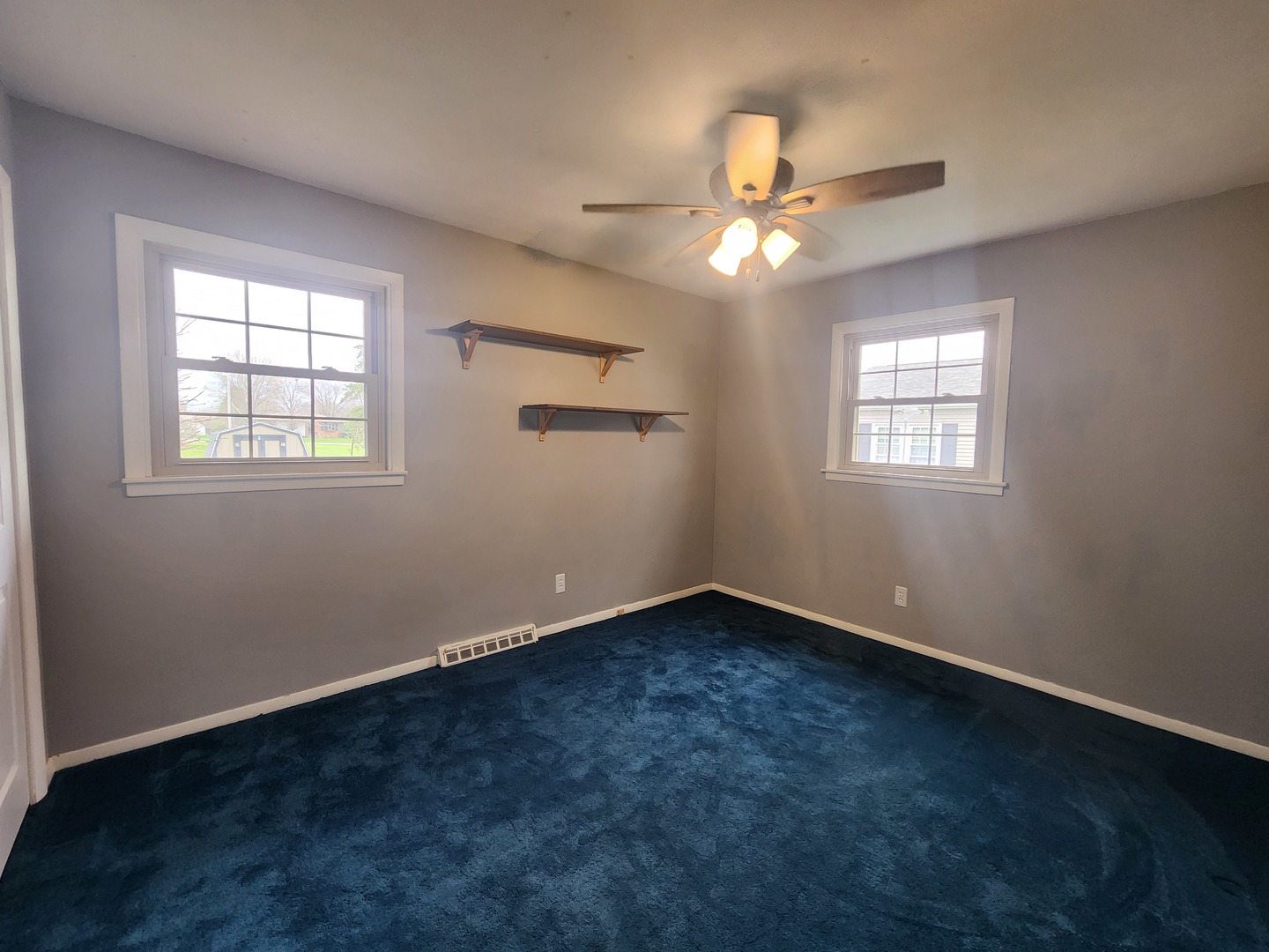 1109 14th Avenue Orion, IL 61273 - Photo 10 of 37 an empty room with windows and fan
