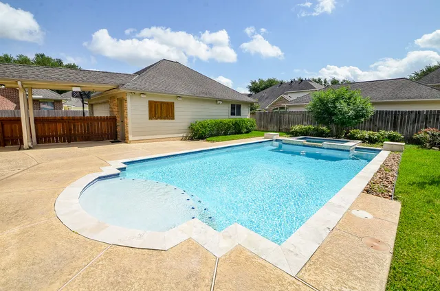 front view of house with swimming pool and porch