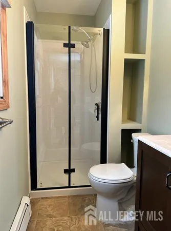 a bathroom with a toilet and a shower