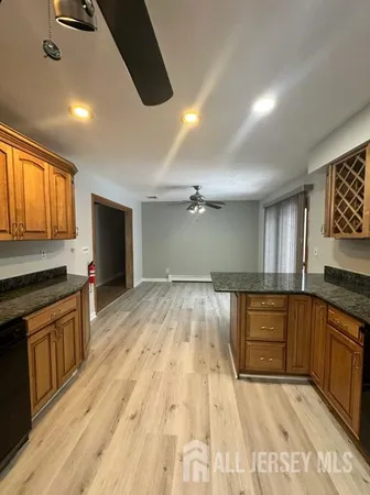 a large kitchen with kitchen island a sink stainless steel appliances and cabinets