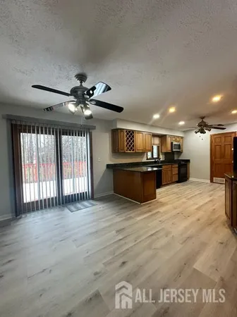 a view of kitchen and a dishwasher with wooden floor