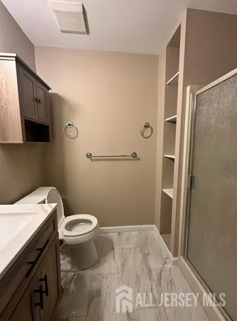 a bathroom with a sink toilet and shower