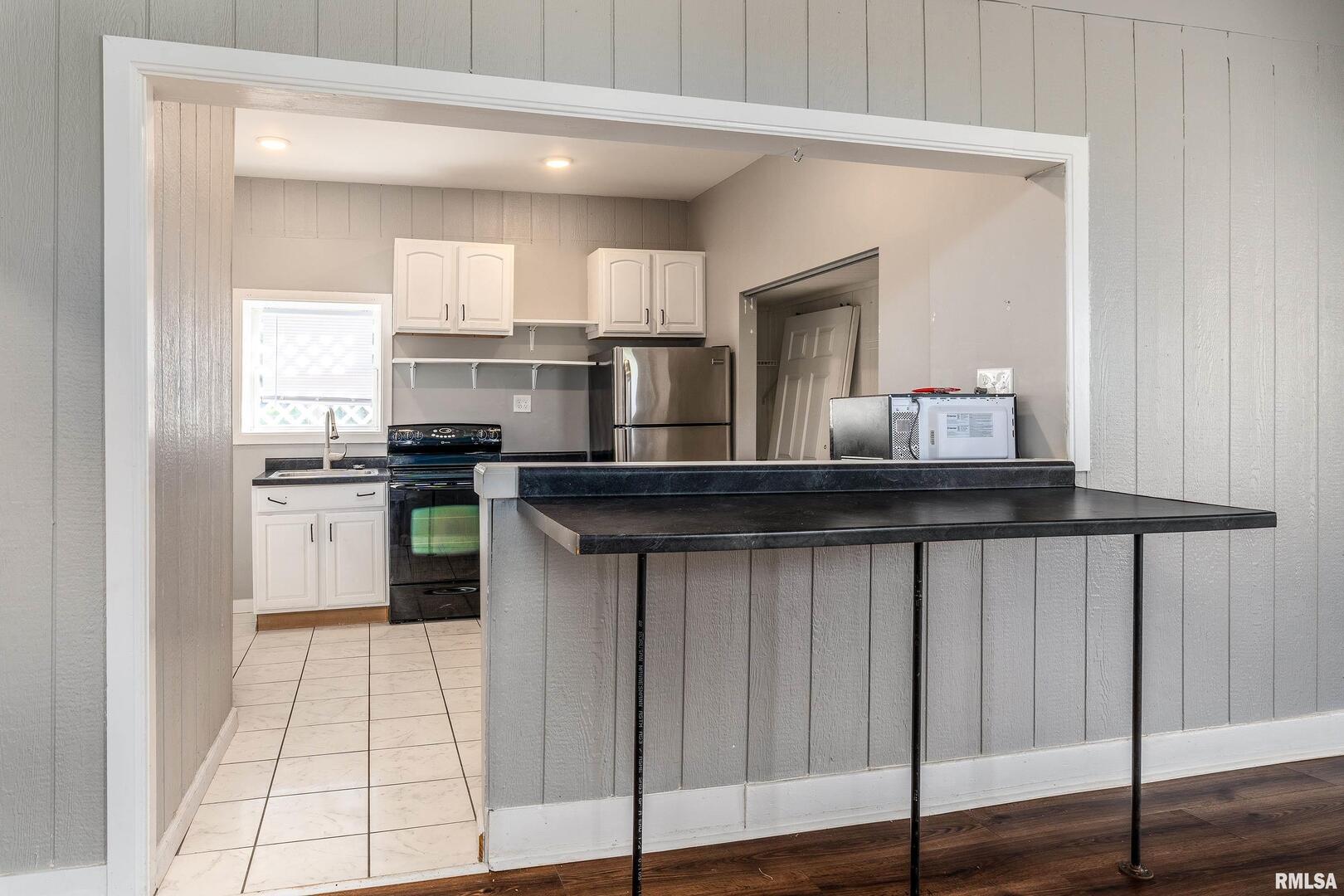 609 South Poplar Street Carbondale, IL 62901 - Photo 11 of 44 a kitchen with stainless steel appliances a sink and cabinets