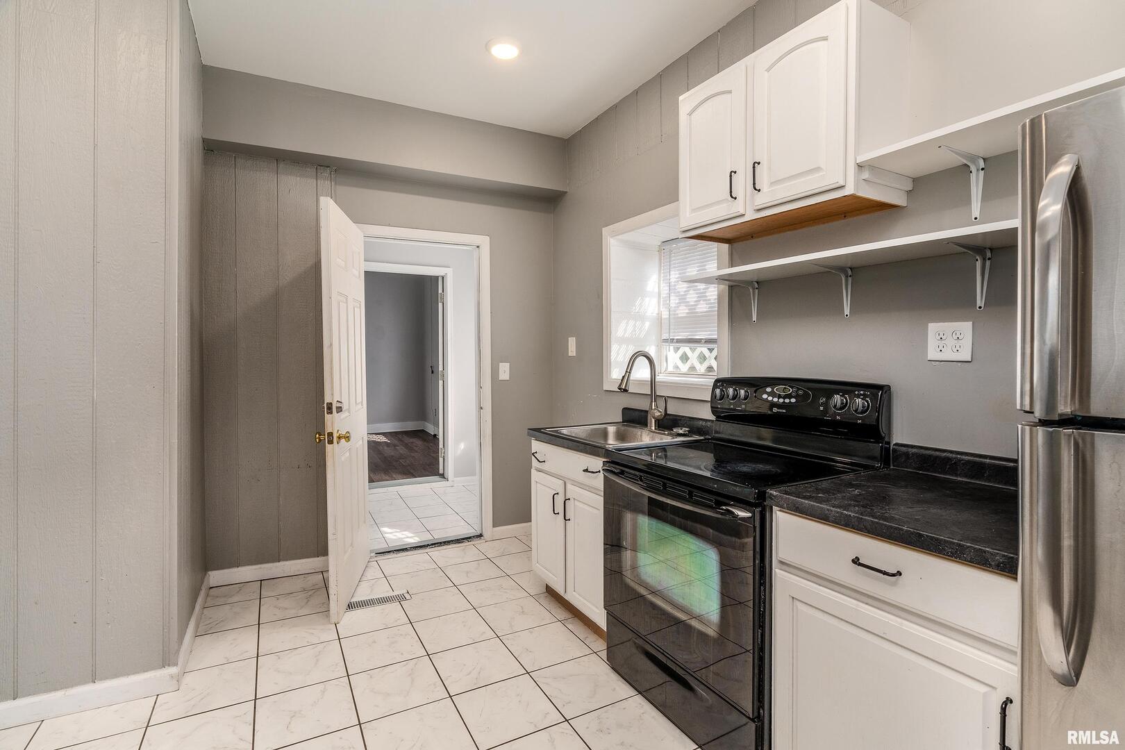 609 South Poplar Street Carbondale, IL 62901 - Photo 13 of 44 a kitchen with cabinets and appliances
