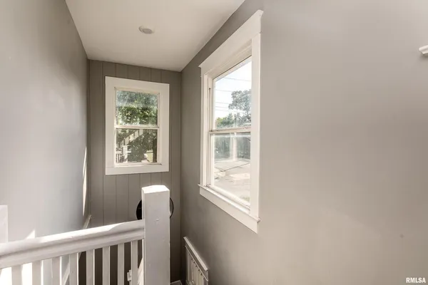 a view of a room that has a window and wooden floor