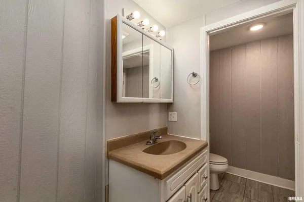 a bathroom with a sink toilet and mirror