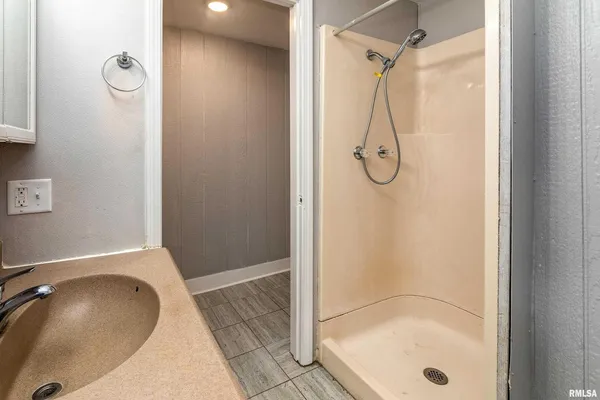 a bathroom with a glass shower door