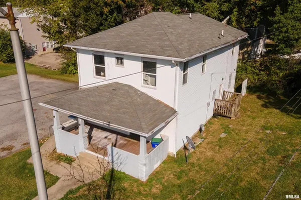 a aerial view of a house with a yard