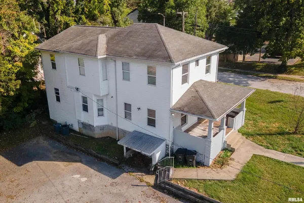 a aerial view of a house with a yard