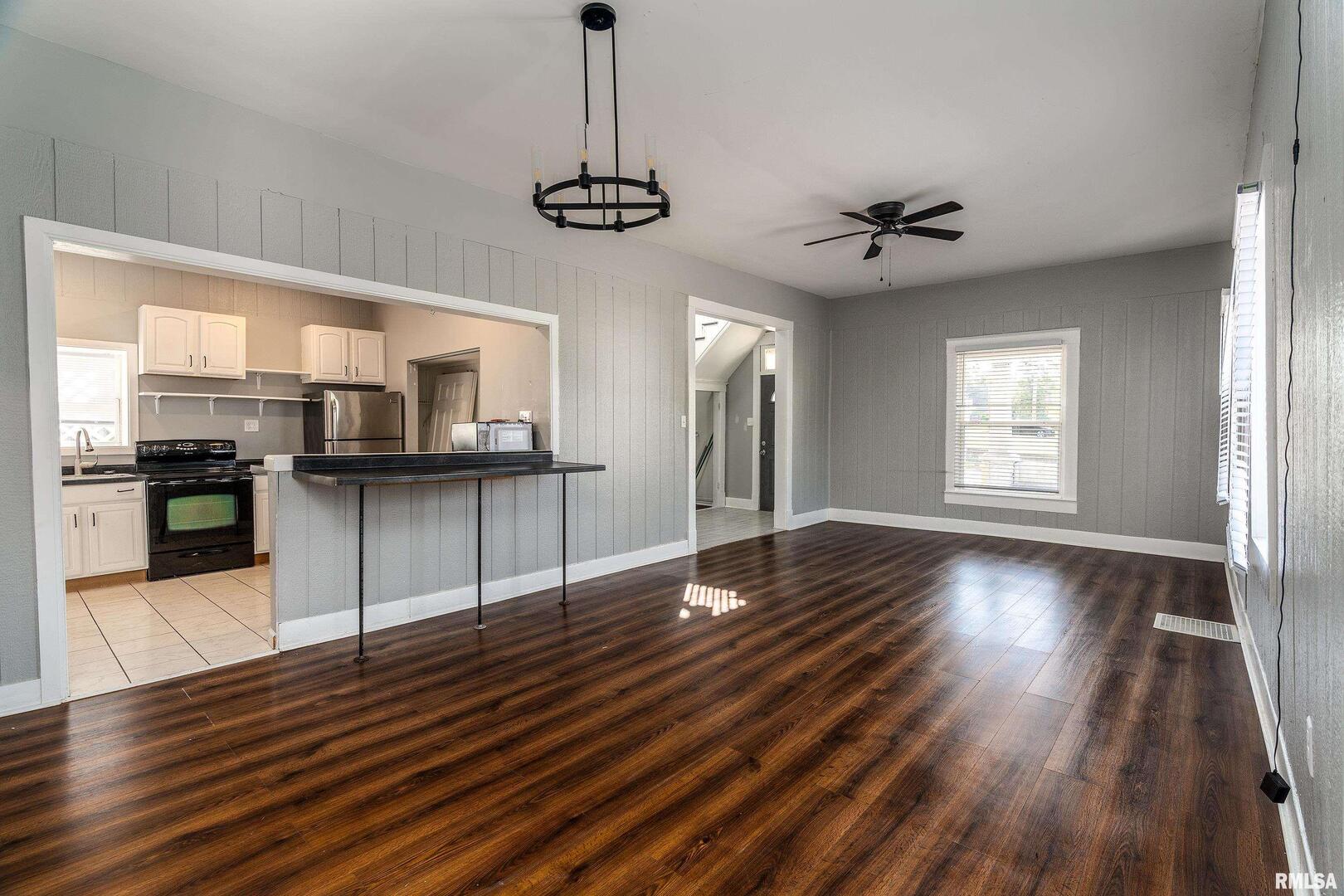 609 South Poplar Street Carbondale, IL 62901 - Photo 10 of 44 a view of a kitchen with a dishwasher a kitchen island wooden floor and a window